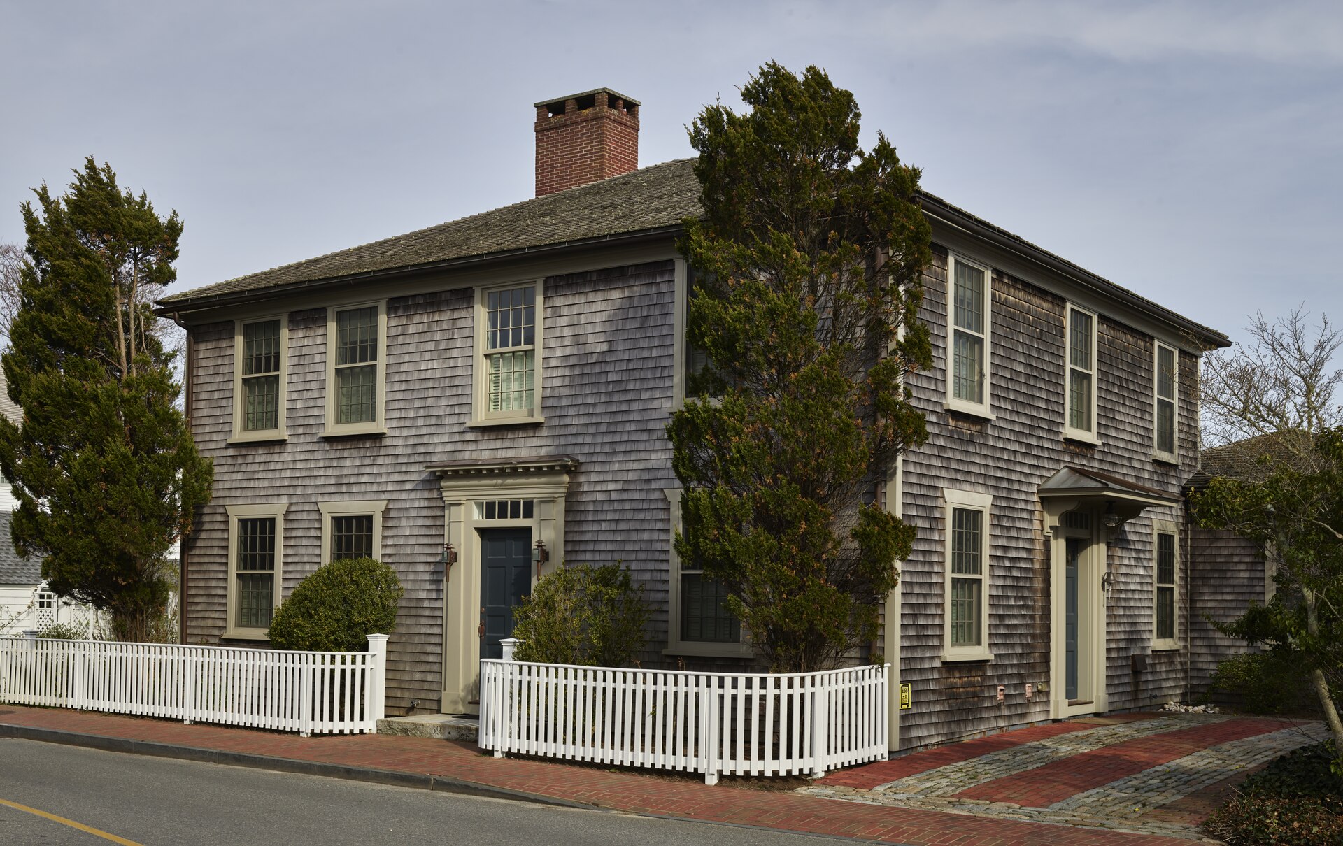 A shingled village home behind a white picket fence, Edgartown