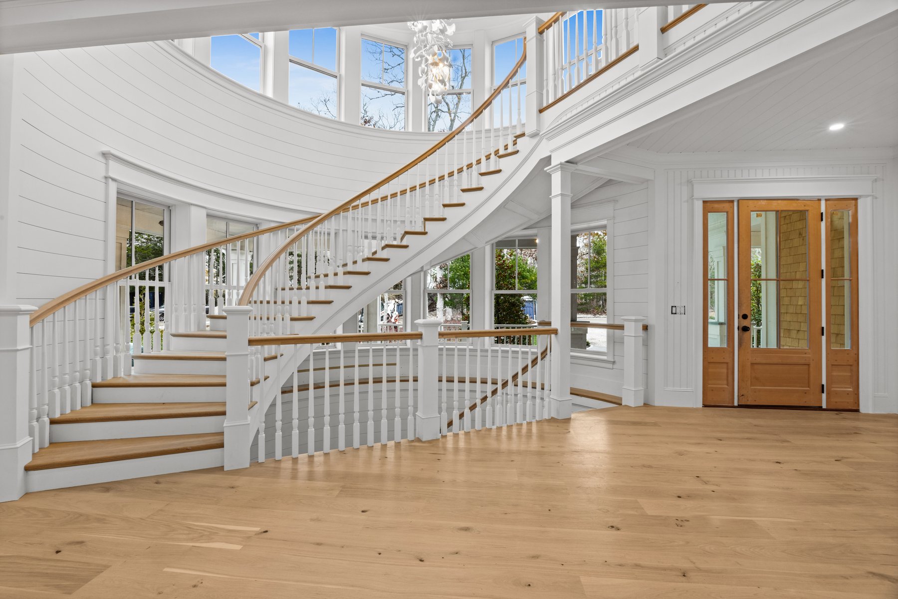 The Morgan — the curved staircase beneath the dome, chandelier above